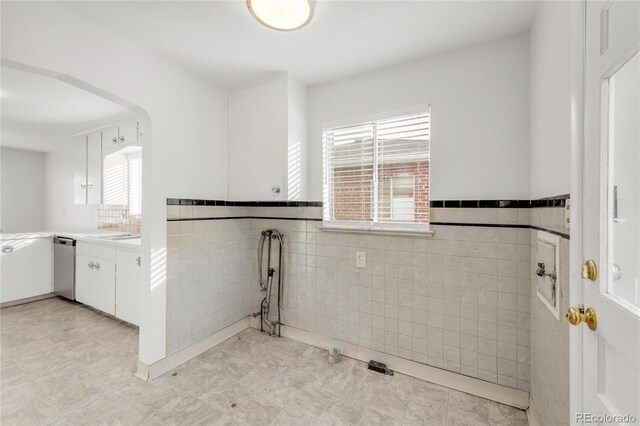 laundry room featuring tile walls