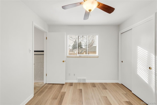 unfurnished bedroom with ceiling fan, a closet, and light hardwood / wood-style flooring