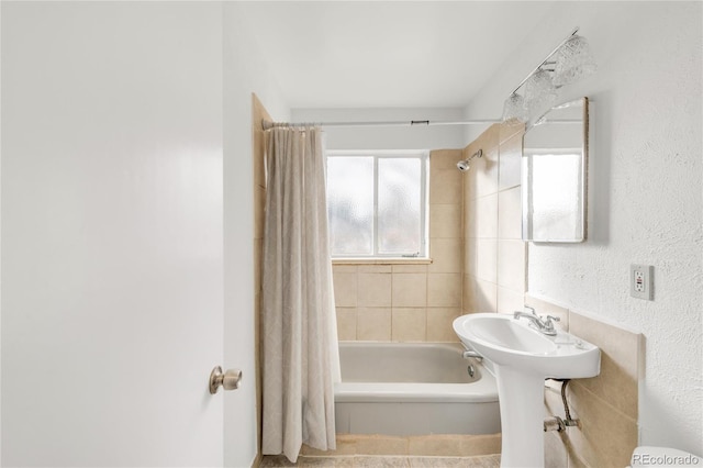 bathroom featuring sink and shower / bath combination with curtain