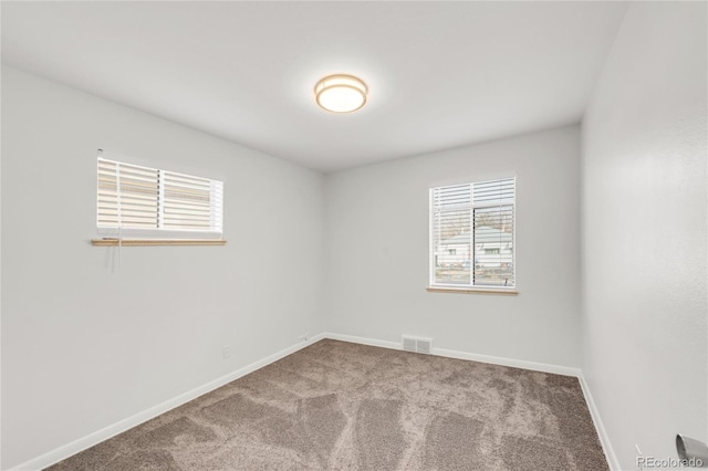 unfurnished room featuring plenty of natural light and carpet floors