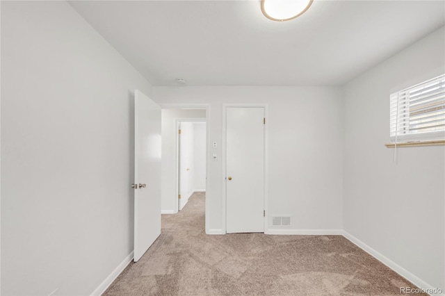 empty room with light colored carpet