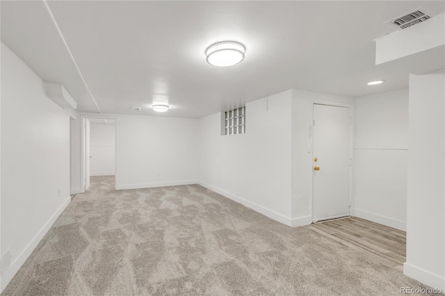 basement featuring light colored carpet