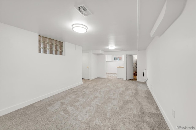 basement featuring light carpet