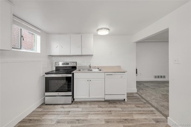 kitchen with electric stove, sink, light hardwood / wood-style flooring, white dishwasher, and white cabinets