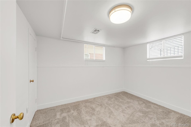 basement featuring light carpet