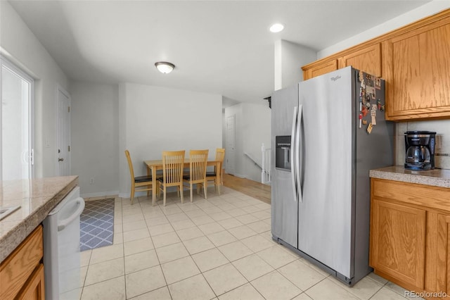 4750 County Road B, Wiggins, CO 80654 - kitchen featuring stainless steel fridge, white dishwasher, brown cabinets, recessed lighting, and tile counters