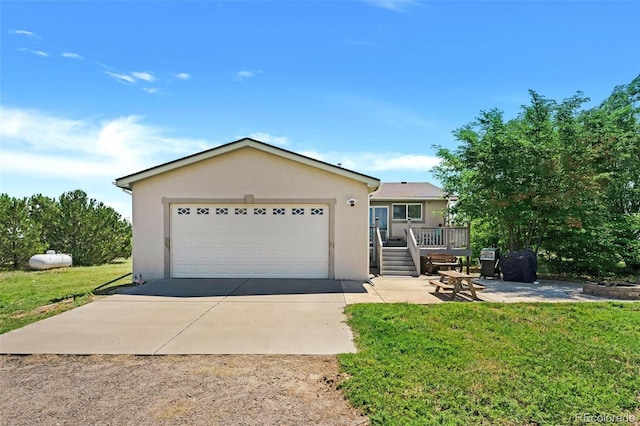 4750 County Road B, Wiggins, CO 80654 - single story home with stucco siding, a garage, a front yard, a deck, and driveway