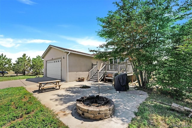 4750 County Road B, Wiggins, CO 80654 - view of patio featuring an outdoor fire pit and a garage