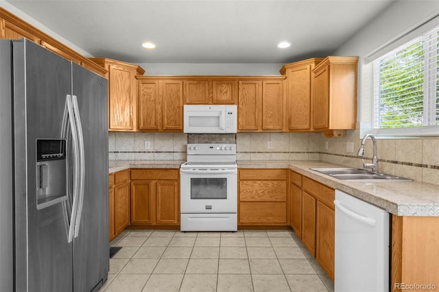 4750 County Road B, Wiggins, CO 80654 - kitchen with white appliances, light countertops, backsplash, light tile patterned floors, and brown cabinets