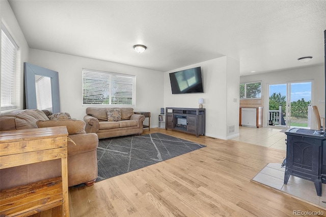 4750 County Road B, Wiggins, CO 80654 - living room with a wood stove and wood finished floors