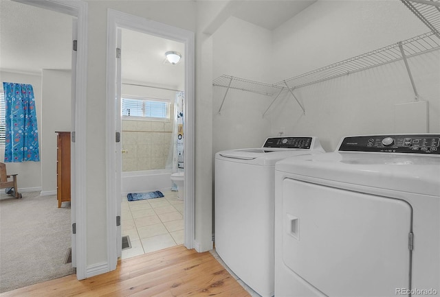 4750 County Road B, Wiggins, CO 80654 - laundry area featuring washing machine and dryer and light wood finished floors
