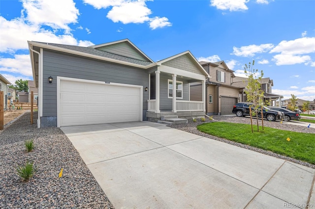 single story home with covered porch, a front yard, and a garage