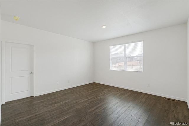 spare room featuring dark hardwood / wood-style flooring