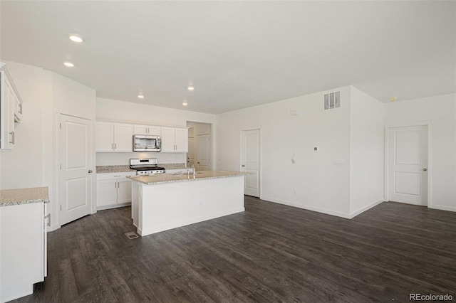 kitchen featuring white cabinetry, sink, dark hardwood / wood-style floors, stove, and a center island with sink