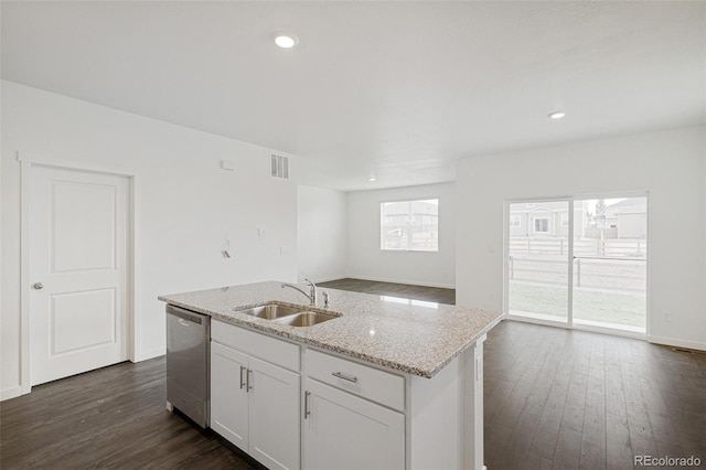 kitchen with dishwasher, white cabinets, a center island with sink, sink, and light stone counters