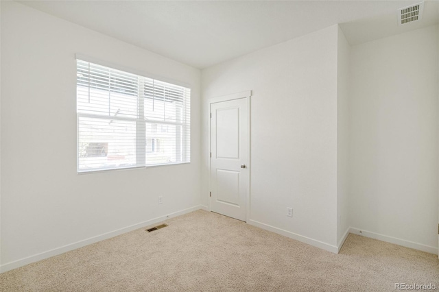 empty room featuring light carpet