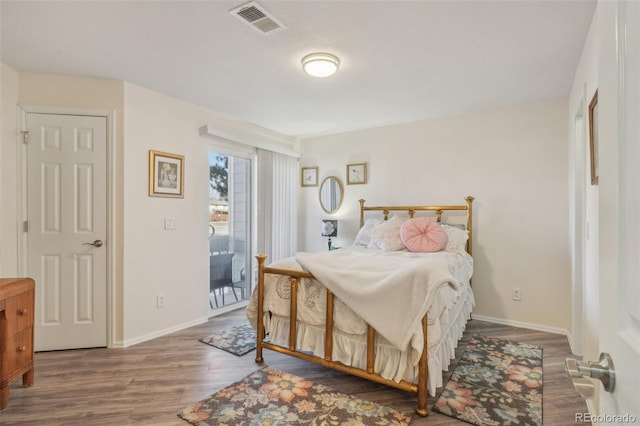 bedroom featuring hardwood / wood-style flooring and access to outside