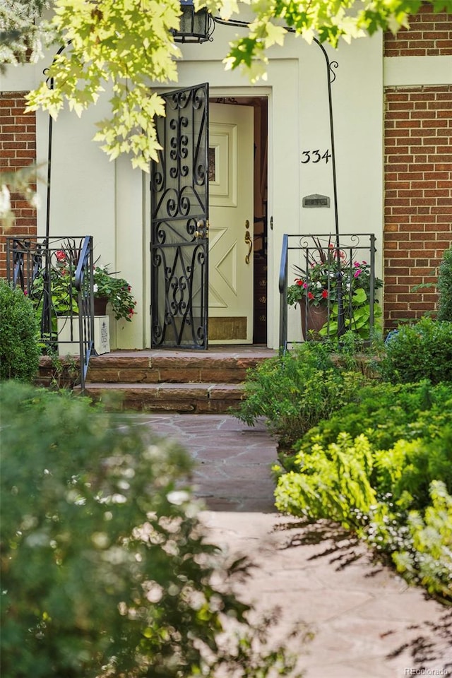 property entrance featuring brick siding