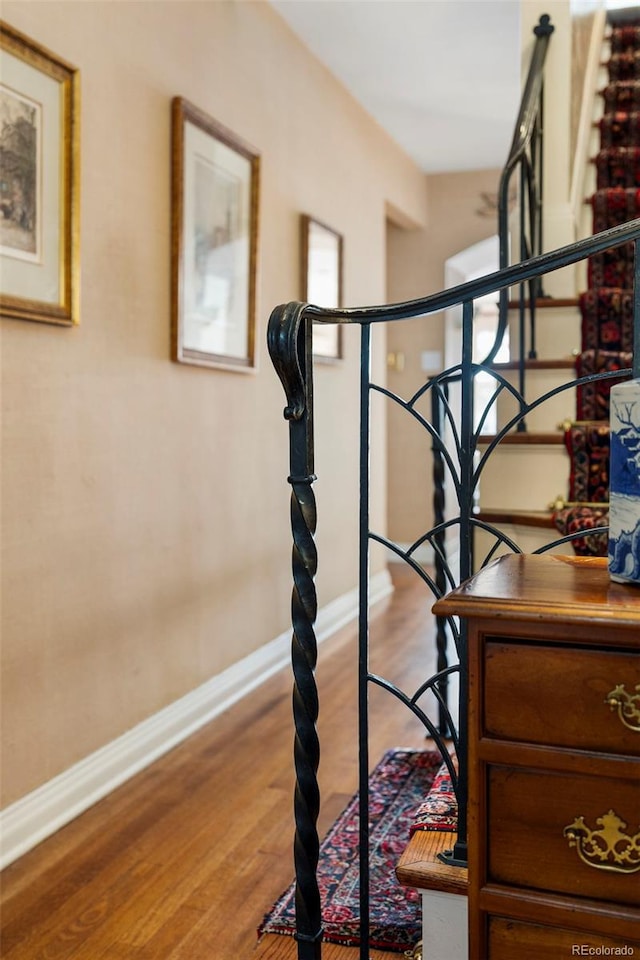 stairs with baseboards and wood finished floors