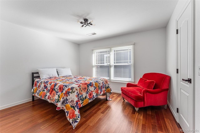 bedroom with dark hardwood / wood-style floors