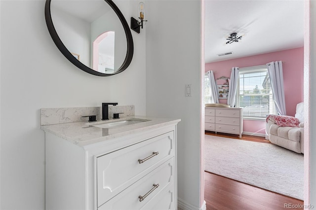 bathroom featuring vanity and wood-type flooring