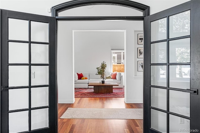 doorway with wood-type flooring