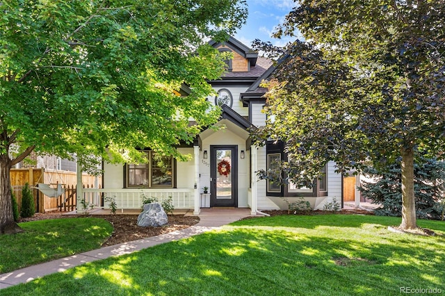 view of property hidden behind natural elements with a front yard