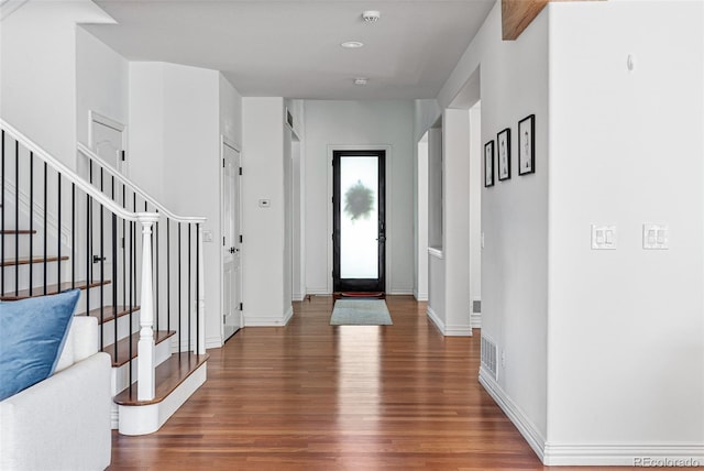 foyer entrance with dark hardwood / wood-style floors