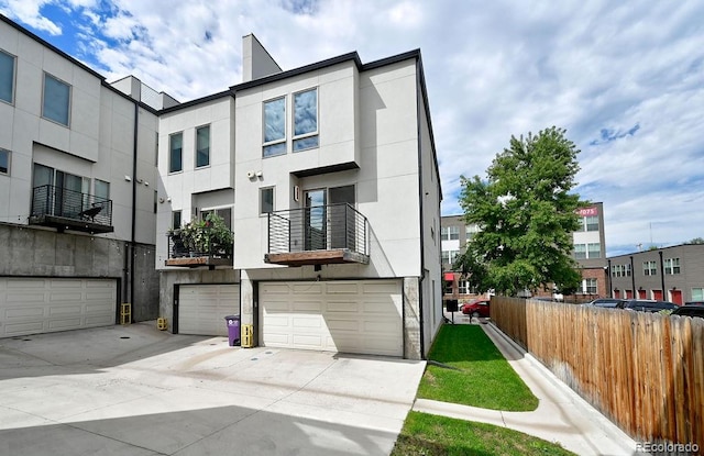 view of property with a balcony and a garage