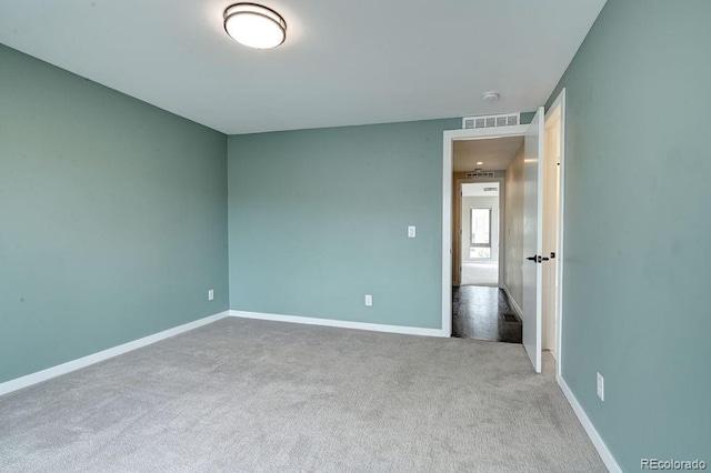 unfurnished room featuring light colored carpet