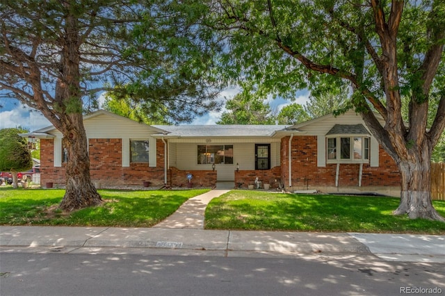 16699 E 7th Ave, Aurora, CO 80011 - single story home featuring brick siding and a front lawn