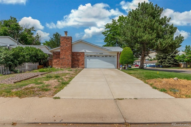 16699 E 7th Ave, Aurora, CO 80011 - view of front of house featuring brick siding, an attached garage, driveway, and a chimney