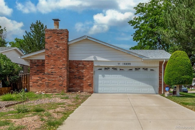 16699 E 7th Ave, Aurora, CO 80011 - view of side of property with brick siding, a garage, concrete driveway, and a chimney