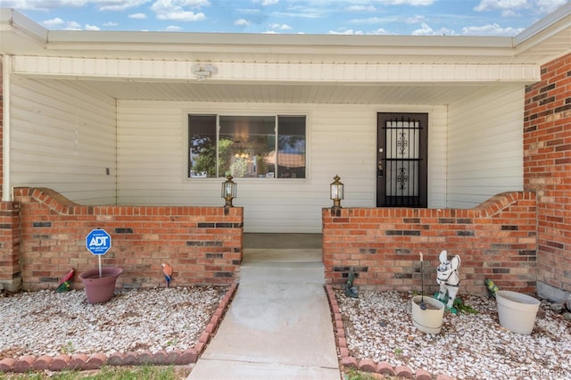16699 E 7th Ave, Aurora, CO 80011 - view of exterior entry featuring covered porch and brick siding