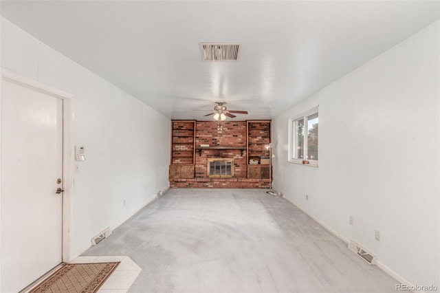 16699 E 7th Ave, Aurora, CO 80011 - unfurnished living room with ceiling fan, a fireplace, and light carpet