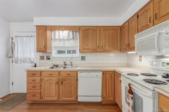 16699 E 7th Ave, Aurora, CO 80011 - kitchen featuring white appliances, tasteful backsplash, light countertops, and light wood-style floors