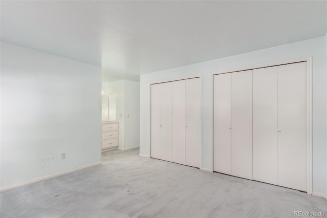 16699 E 7th Ave, Aurora, CO 80011 - unfurnished bedroom featuring multiple closets and carpet floors