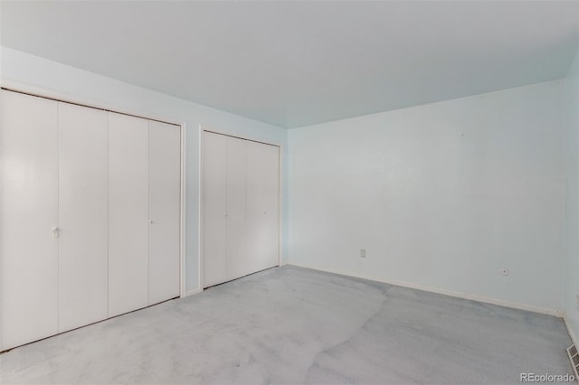 16699 E 7th Ave, Aurora, CO 80011 - unfurnished bedroom featuring multiple closets and carpet floors