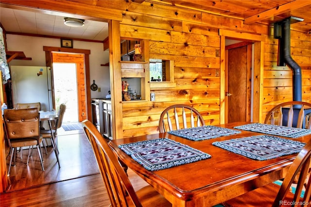 446 Chief Trl, Como, CO 80456 - dining room featuring wood walls, wood finished floors, and a wood stove