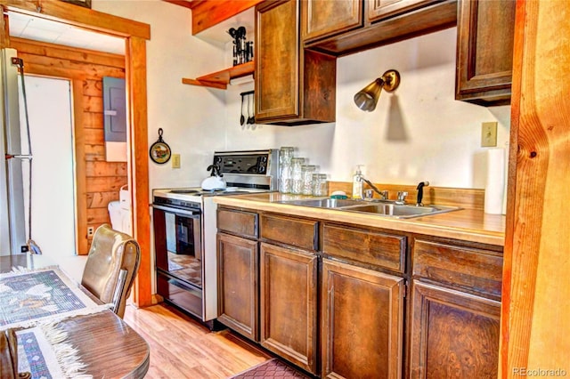 446 Chief Trl, Como, CO 80456 - kitchen with range with electric stovetop, a sink, open shelves, light countertops, and light wood-style flooring