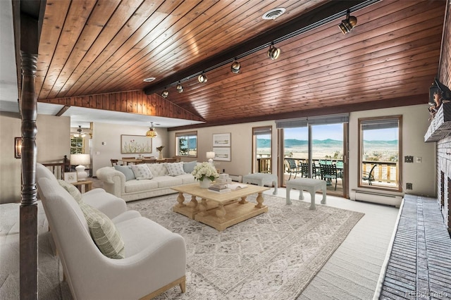 living room featuring wood ceiling, light colored carpet, lofted ceiling, and rail lighting