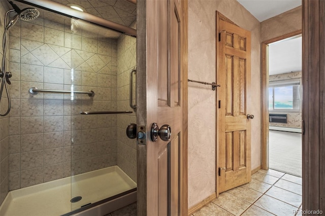 bathroom with a baseboard radiator, tile patterned floors, and an enclosed shower