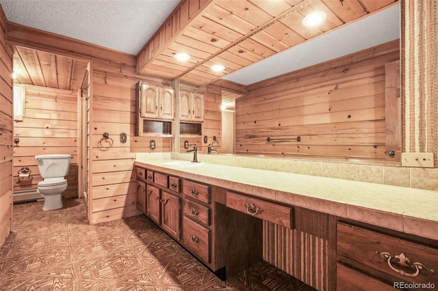 bathroom featuring vanity, wood ceiling, toilet, and wood walls