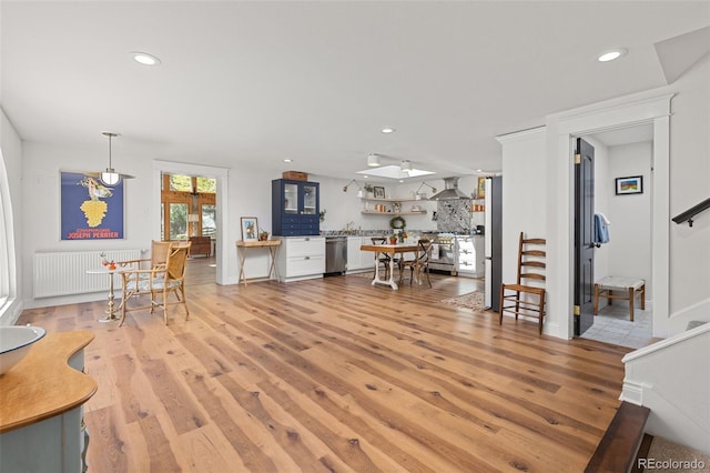 1669 Apple Valley Rd, Lyons, CO 80540 - living room featuring radiator heating unit, light wood-type flooring, recessed lighting, and stairs