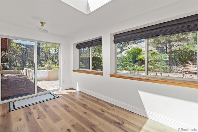 1669 Apple Valley Rd, Lyons, CO 80540 - unfurnished room with baseboards, wood finished floors, and a skylight