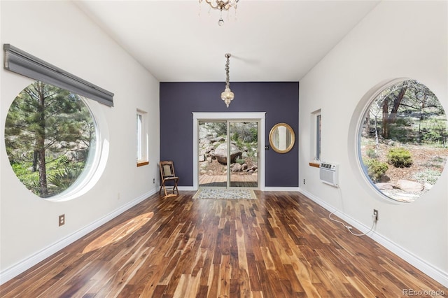 1669 Apple Valley Rd, Lyons, CO 80540 - foyer featuring wood finished floors, baseboards, and a wall mounted AC