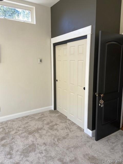 1669 Apple Valley Rd, Lyons, CO 80540 - unfurnished bedroom featuring carpet floors, a closet, and baseboards
