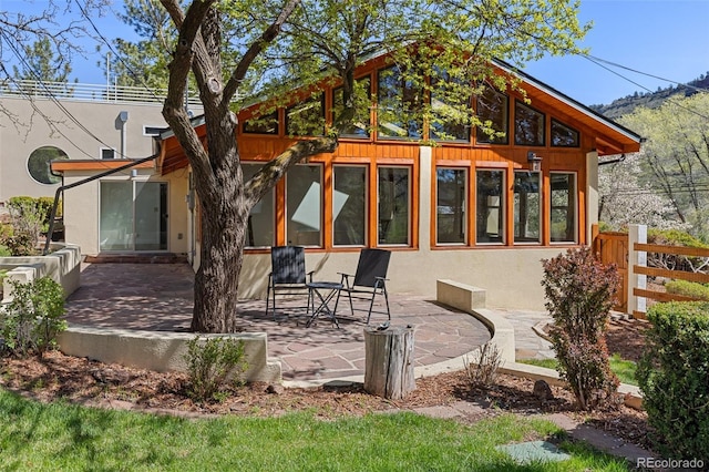 1669 Apple Valley Rd, Lyons, CO 80540 - back of property featuring a patio, stucco siding, and fence