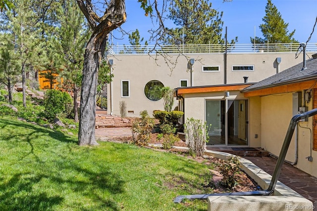 1669 Apple Valley Rd, Lyons, CO 80540 - back of house with stucco siding and a yard