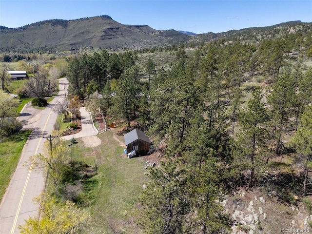 1669 Apple Valley Rd, Lyons, CO 80540 - drone / aerial view of a mountainous background and a heavily wooded area